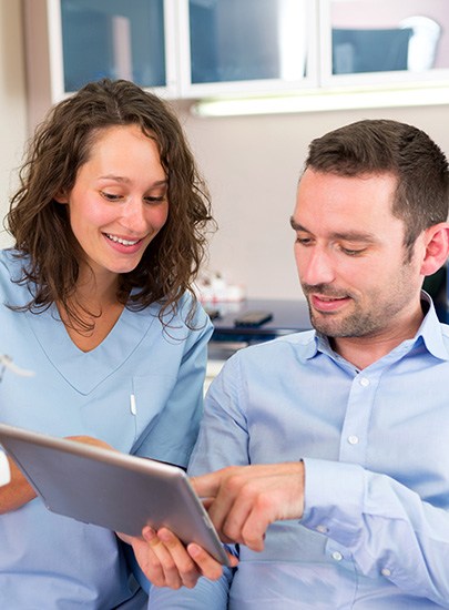 Dental hygienist holding toothbrush and model teeth in Chula Vista