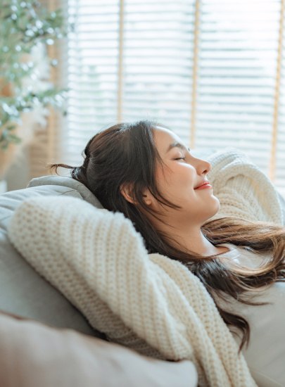 Closeup of smiling woman relaxing at home