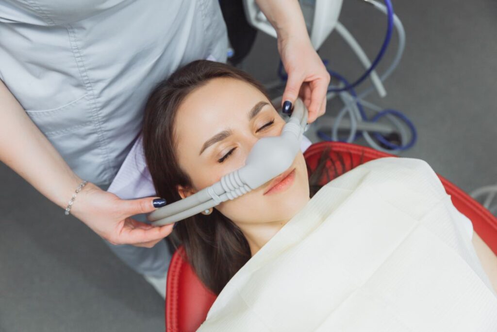 A woman getting nitrous oxide treatment at the dentist.